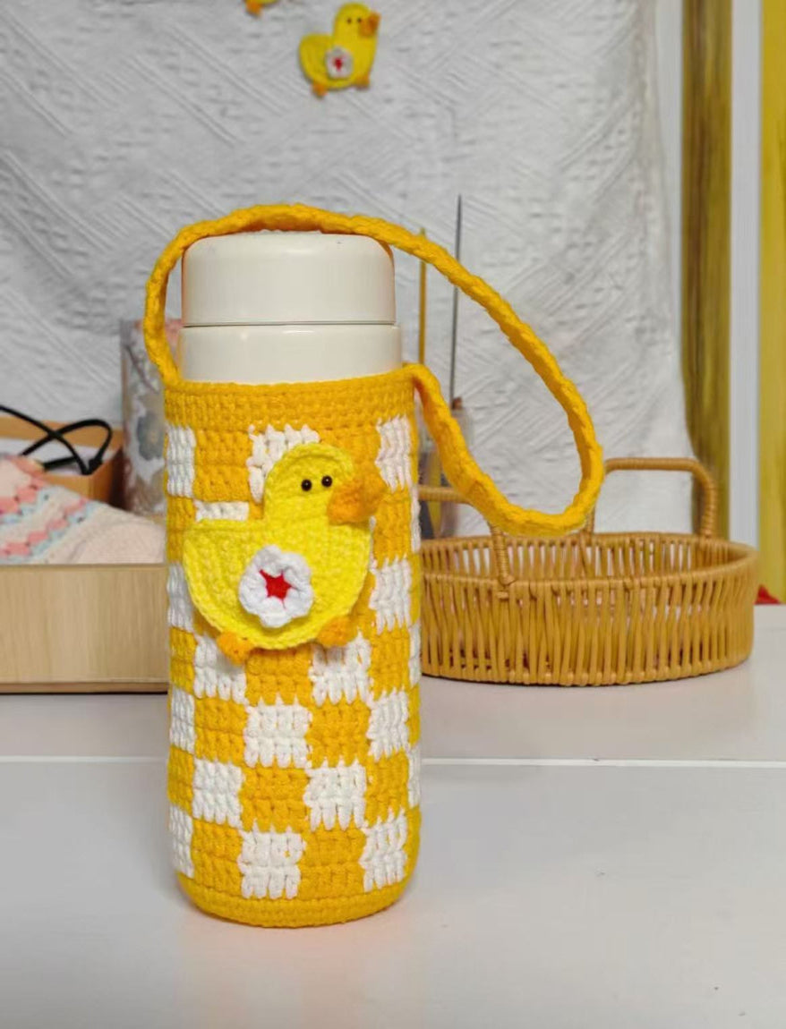 Yellow and white checkered water bottle holder with duck design on a white surface.